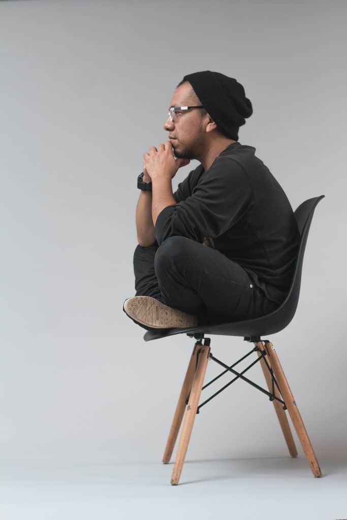 It's ok to overthink. An image of a man, deep in thought, sat on a chair.